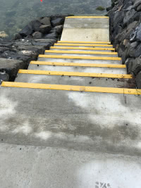 steps down rocky slope to the ocean