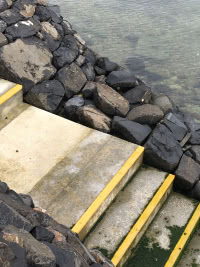 steps down rocky slope to the ocean