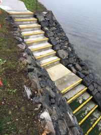 steps down rocky slope to the ocean